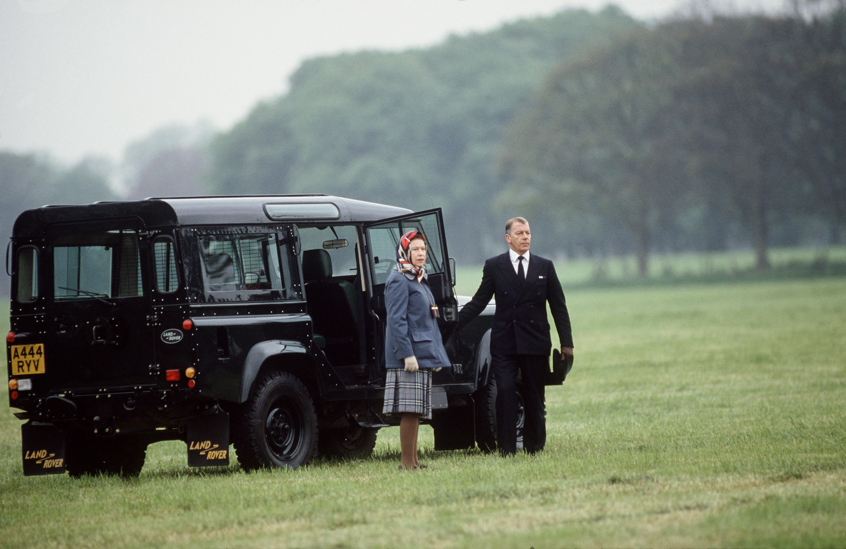The Queen's driver pauses while the Queen prepares to board her Land Rover Defender.