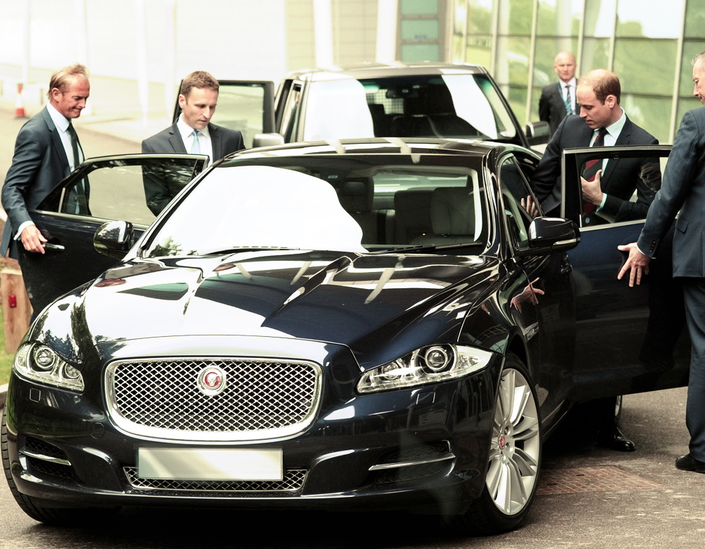 Prince William is helped into his Jaguar XJ for the day.