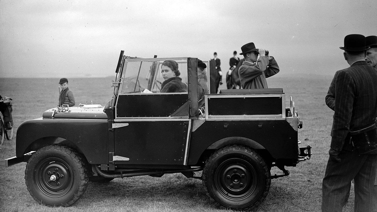 The Queen and Prince Phillip survey the scene from their Land Rover Defender in 1953.