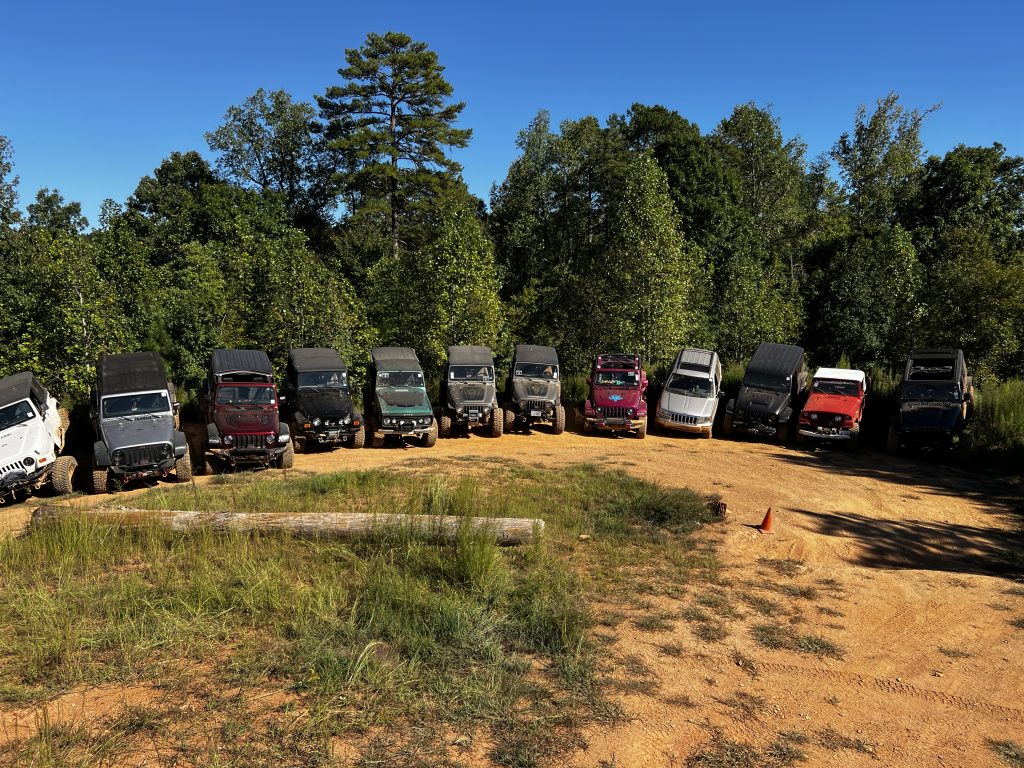 Jeep Wranglers and Grand Cherokees line up on a hill within the Uwharrie National Forest trails as part of the 2022 Jeep Jamboree.